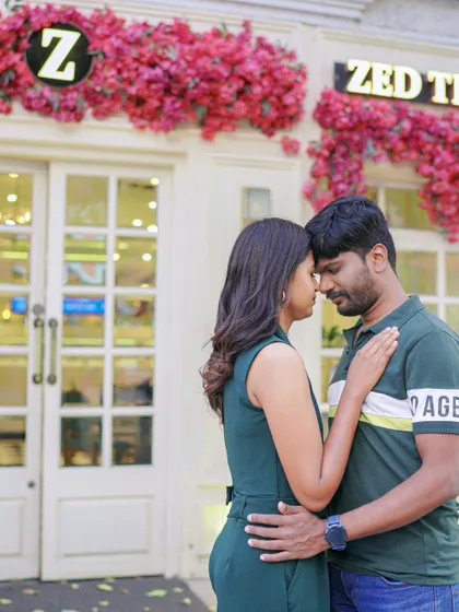 An intimate forehead touch in front of a beautifully decorated bakery. This urban setting provides a charming and romantic backdrop for a couple shoot.