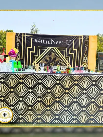A closer look at our Great Gatsby-themed bar. The black and gold Art Deco pattern on the bar front and the custom hashtag backdrop created a glamorous 1920s feel.