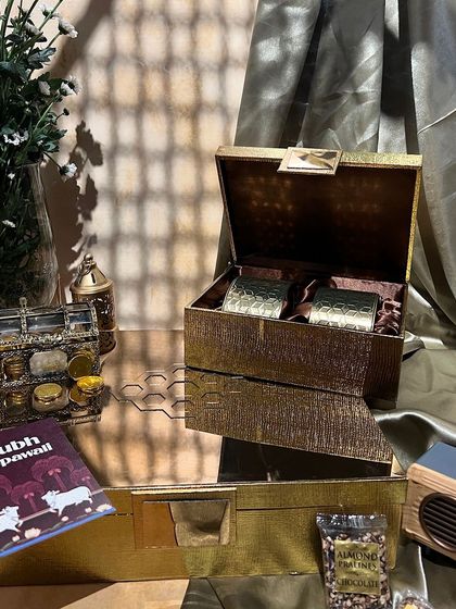 A luxurious gold-textured box from our Diwali collection. It's perfect for creating a high-end hamper with items like a bluetooth speaker and gourmet snacks.