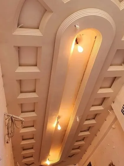 This is a coffered ceiling design for a long passage, shown before the final paint and lighting installation. Each recessed panel is crafted with precision.