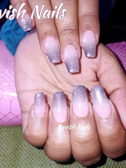 A classic glitter ombre with silver glitter fading into a soft pink base on long square nails.