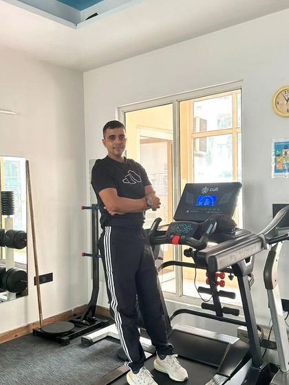 Posing by the treadmill, a key machine in our fat loss programs.