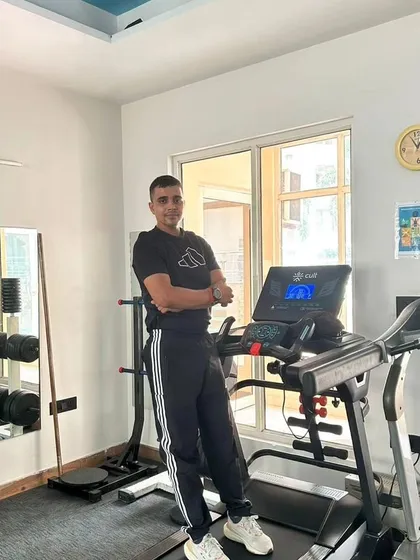 Posing by the treadmill, a key machine in our fat loss programs.