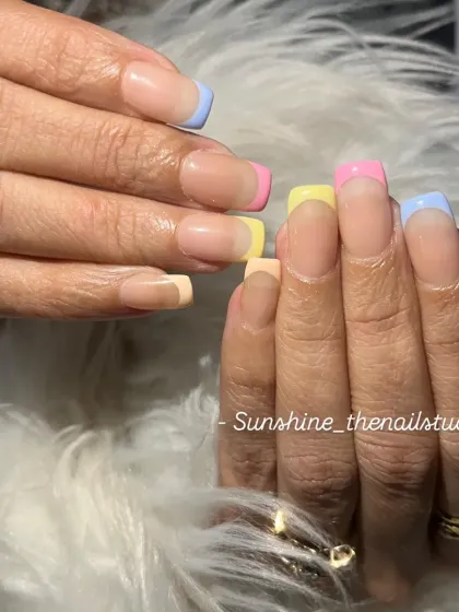 Pastel rainbow French tips on square nails.