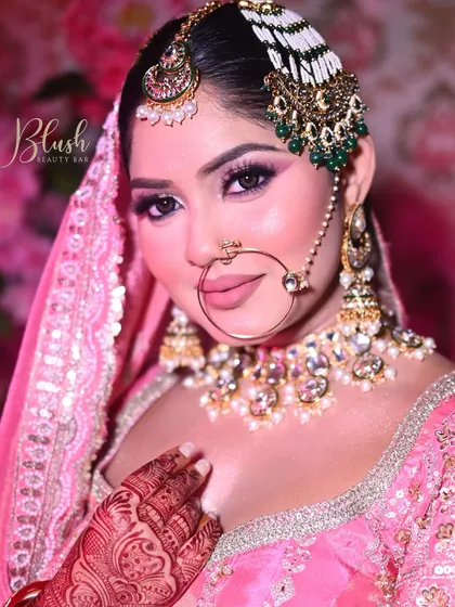 A classic pink bridal lehenga calls for a romantic makeup look. Here, I've used a blend of pink and shimmer eyeshadows to make the eyes pop, paired with a soft pink lip and glowing skin, perfect for a traditional Indian wedding ceremony.