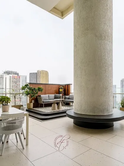 This shot showcases the thoughtful layout of the terrace, with a large structural pillar cleverly integrated into the design with a circular bench.