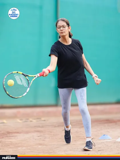 Focus and precision in every shot. This young athlete demonstrates the powerful forehand technique we develop through our structured training programs on the clay court.