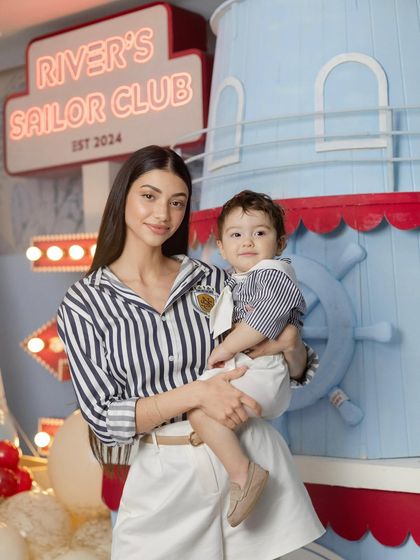 A beautiful portrait of the mother and child, capturing a sweet moment from the celebration.