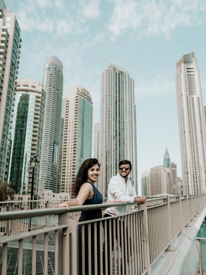 A stylish shot of the couple on a bridge in the Dubai Marina, capturing the vibrant city life.