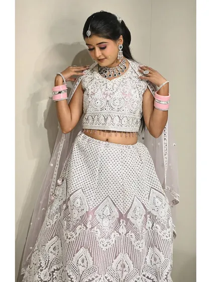 The full view of the white threadwork lehenga. This outfit is a great choice for someone who wants a non-traditional color for their ceremony or reception.
