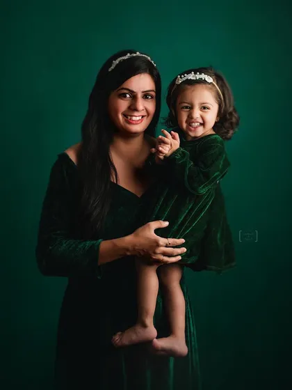 Twinning in green velvet, this mother and daughter share a happy, connected moment. I love capturing these matching-outfit shoots.