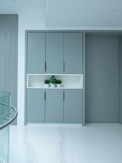 Images from the "Shades of White" project, focusing on how minimalism, light, and subtle details like a curved glass railing or a pop of color from a chair can create a powerful architectural statement.