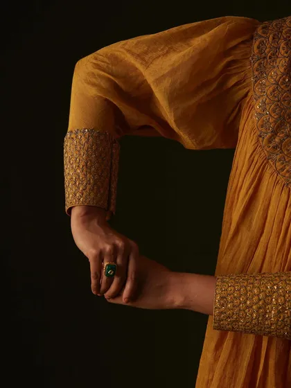 Art direction for Aurul Clothing, inspired by classic portrait paintings. This shot focuses on the intricate hand-embroidery on the cuffs.