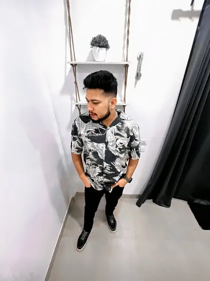 A more casual, indoor shot. Even in a relaxed setting, the focus is on a clean, stylish look.