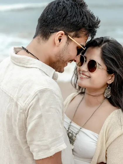 A warm, sun-kissed close-up of the couple on a Goa beach. This intimate portrait captures their affection and the beautiful golden light of a seaside afternoon.
