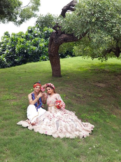 A wide shot showing the complete look in a beautiful natural setting. The makeup stands out even from a distance.