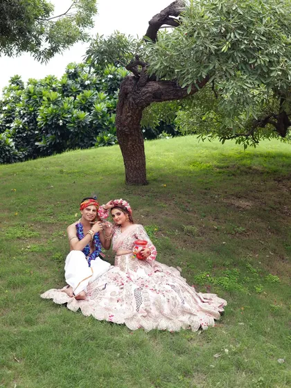 A wide shot showing the complete look in a beautiful natural setting. The makeup stands out even from a distance.