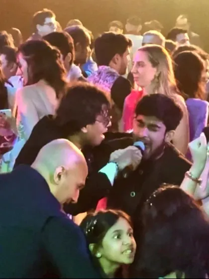 The best moments are when the crowd becomes part of the show. Here I am sharing the mic with a guest at a wedding sangeet, because my performances are all about creating a shared, interactive experience.