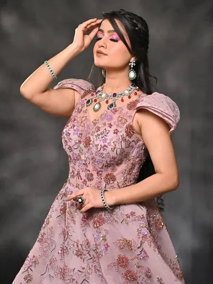 This pose captures the dreamy quality of the makeup and styling. The light hits the shimmer on the eyelids, showcasing the dimension of the cut-crease eye makeup.