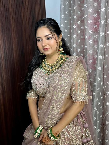 Another angle of this stunning soft glam. The makeup perfectly complements her heavy jewelry and pastel lehenga, creating a harmonious and sophisticated look.