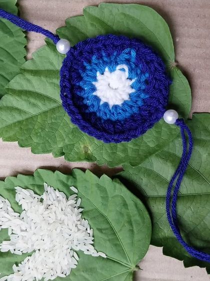 My evil eye design adapted into a beautiful handmade rakhi. It's a modern twist on a traditional thread, perfect for protecting your sibling.