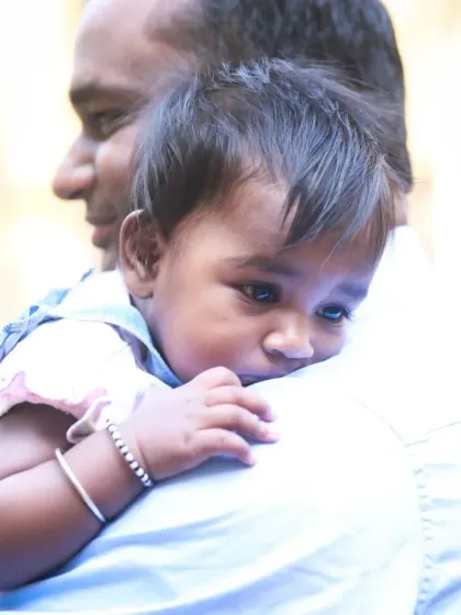 A tender moment with a daughter resting her head on her father's shoulder. It’s a quiet, loving portrait that speaks volumes about their connection.