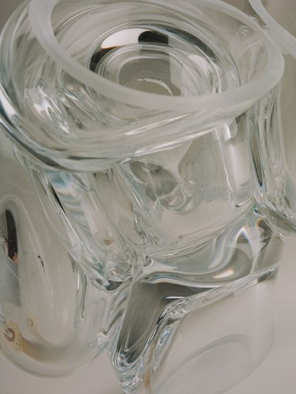 An extreme close-up of a clear glass Bocci pendant, revealing the intricate details and imperfections that make each piece unique.