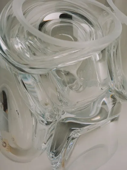 An extreme close-up of a clear glass Bocci pendant, revealing the intricate details and imperfections that make each piece unique.