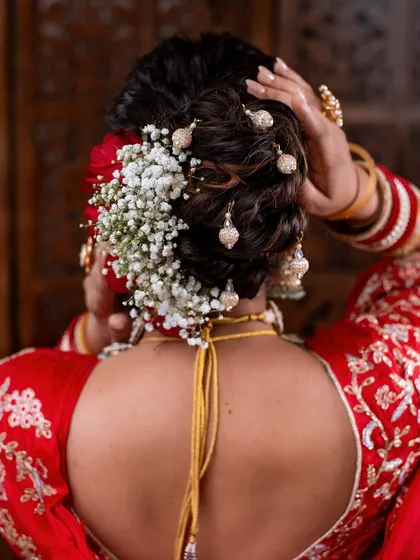 Details matter. A close-up of a beautiful floral bun with traditional jhumki-style hair accessories.