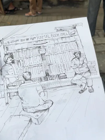 An urban sketch of a classic bookstall in Malleswaram, Bengaluru. It's not a cafe, but these little stalls are the heart of the city's culture, just like cafes.
