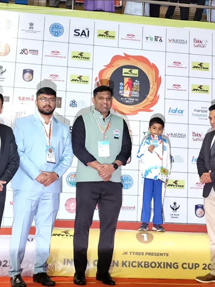Posing with officials at the India Open, our young gold medalist represents the future of kickboxing. We provide the platform for young talent to shine.