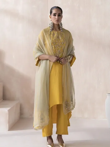 A full-length view of a look I styled for a festive collection. The bright yellow kurta with an asymmetrical hem is paired with a sheer, lightly embroidered dupatta for an elegant and modern ethnic look.