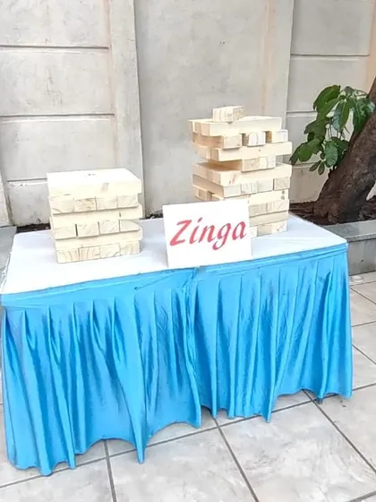 Our giant Jenga game, which we call 'Zinga', takes the classic tabletop game to a new level. It's a great icebreaker that requires strategy and a steady hand.