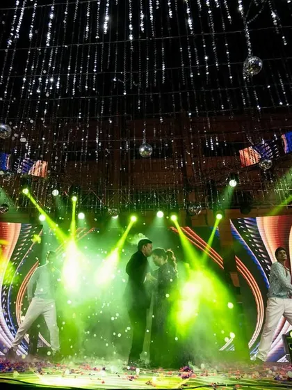 A wide shot of a spectacular Sangeet stage, showcasing the scale of production we can handle, from LED screens to professional dancers.