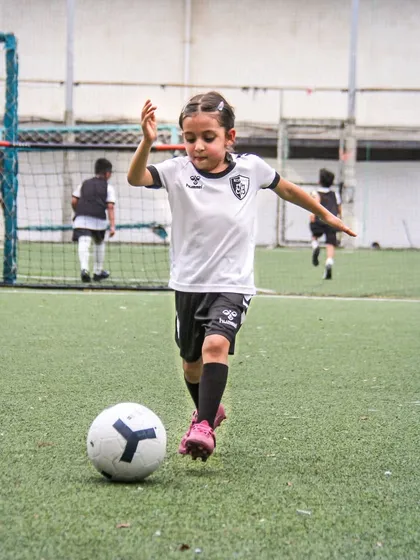 Running towards the goal with focus and energy. We empower our young girls to be active, assertive, and passionate about the game.
