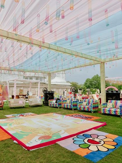 An overview of a fun-filled carnival Mehendi, with a colorful dance floor, eclectic seating, and multiple themed photo-op corners, all designed to create a lively and interactive celebration.