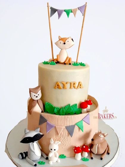 This is one of the cutest jungle-themed cakes I've ever made. This two-tier woodland animal cake features a fox, owl, raccoon, and bunny. The design was provided by the client, and it was a pleasure to create.