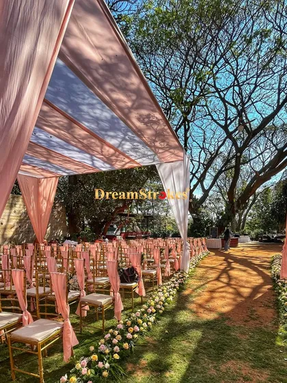 The elegant guest seating arrangement along a flower-lined aisle, showcasing the attention to detail in our event setups.