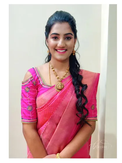 This is a great example of a subtle and natural look for a wedding guest. The saree is draped neatly to highlight the cold shoulder blouse, and the simple hairstyle keeps it elegant and comfortable for the entire event.