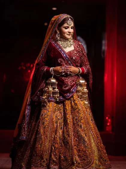 A full-length shot of the bride in a stunning, heavily embroidered lehenga, looking like a true queen.