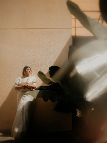 A dreamy bridal portrait with a creative flair. The light leaks and foreground blur add an ethereal quality to this shot of the bride basking in the sun.