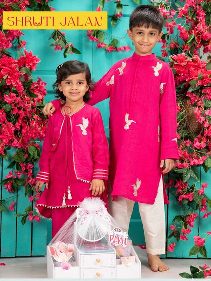 This brother and sister duo is ready for Rakhi in my festive fuchsia pink set. The boy's kurta and girl's jacket feature delicate white bird embroidery, a signature detail I love to add.