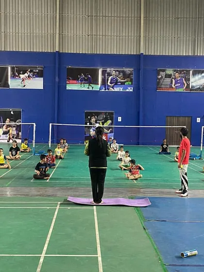 A full-group view of a guided yoga session on the courts. We believe in a holistic approach to training, combining on-court skill with off-court physical and mental conditioning.