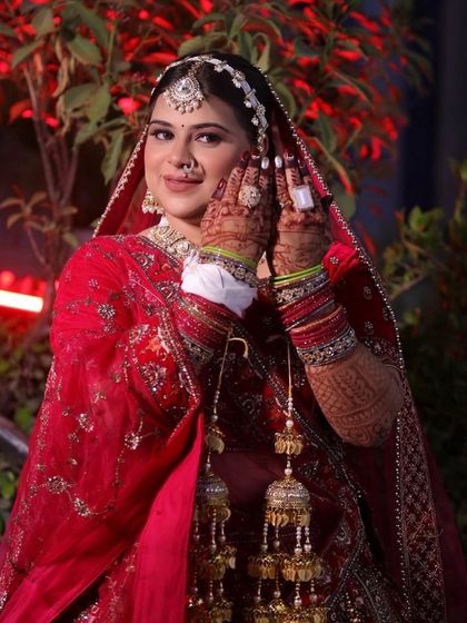 Another angle of this stunning bride, showcasing the beautiful side profile and the details of her nose ring and mehndi.