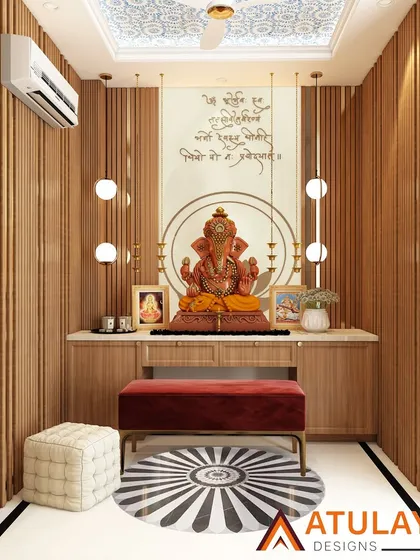 This modern pooja room combines tradition with contemporary design. It features a serene Ganesha idol against a backdrop of wooden slats, a marble platform, and elegant Sanskrit shlokas, all illuminated by beautiful pendant globes and brass-finished diyas.