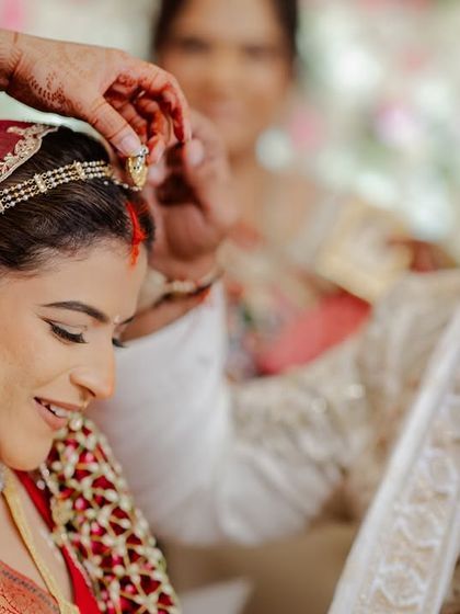 A tender moment during the sindoor ceremony. We believe it's these small, intimate rituals that hold the most meaning, and we ensure they are captured beautifully.