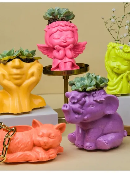 My collection of handcrafted Jesmonite planters is all about adding a pop of personality to your space. This image shows the variety of quirky, vibrant figurine shapes I offer, from playful cats to serene angels, each ready to hold a small plant or your favorite trinkets.