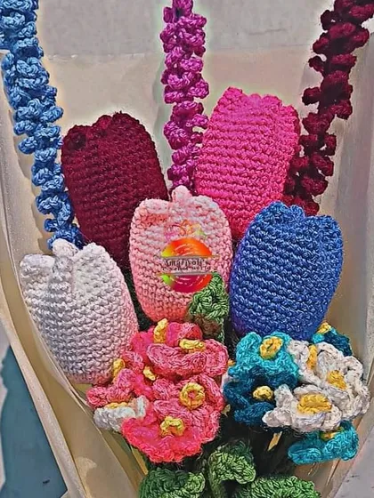 A beautiful custom bouquet I made, wrapped and ready for gifting. This arrangement includes a variety of my crochet flowers like tulips and lavender in a cool color palette of blues, purples, and pinks.