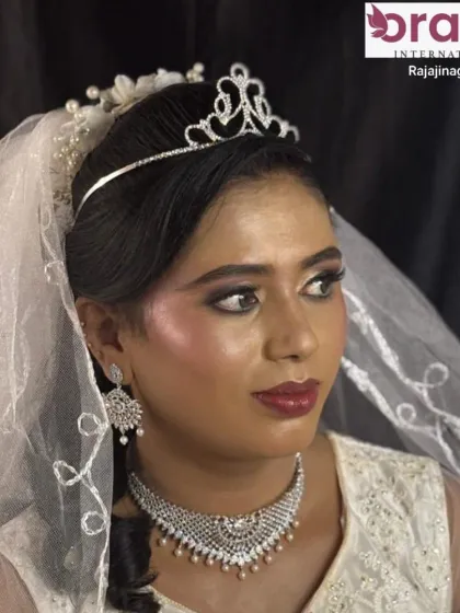 A beautiful Christian bride makeover with dewy makeup, a key trend you'll learn in our courses. The look is completed with a delicate tiara and veil.