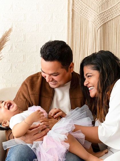 A moment of pure joy as parents tickle their laughing baby. Capturing these candid, happy family moments is the goal of my lifestyle sessions.